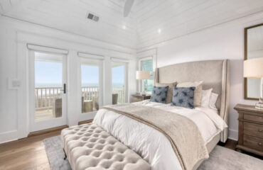 coastal bedroom with beach view from patio door