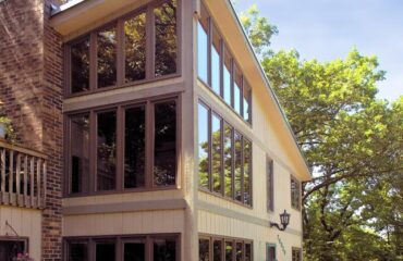 outdoor home with lots of glass windows