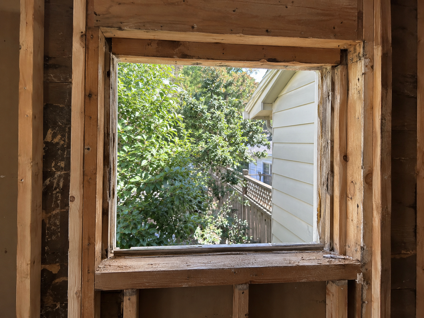 Window rough opening exposed down to the studs during a full frame window replacement